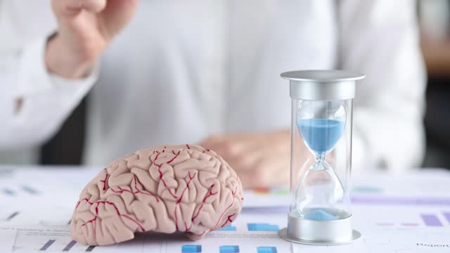 Business woman holding bitcoin coin in front of brain mockup and hourglass 4k movie slow motion