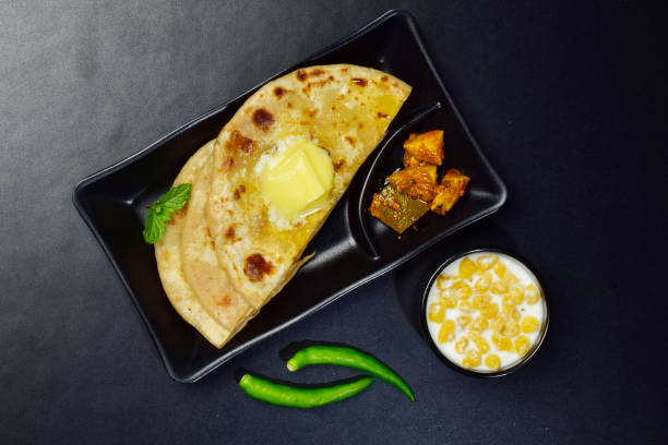 istock Butter paratha with raita and pickle top view 1682019027