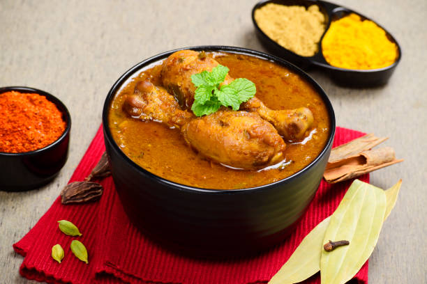 istock Indian style spicy chicken curry in bowl, whole spices 1682019844