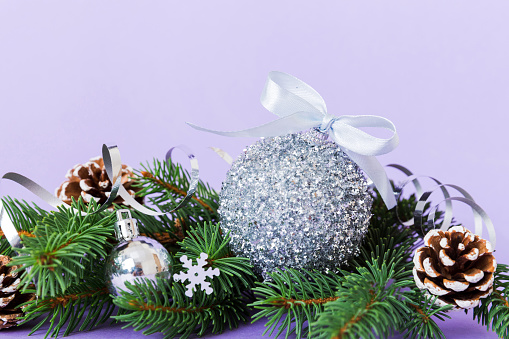 New Year Christmas tree toy, branches of a christmas tree, New Year decorations on a colored background.