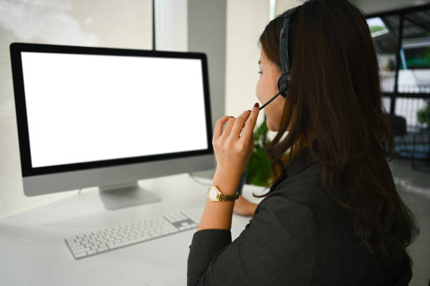 istock Side view of female telemarketer operator wearing headset and working on support hotline in modern workplace 1682054829