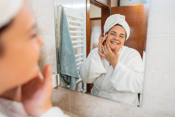 istock Young Woman Looking At Herself In The Bathroom Mirror 1682063867