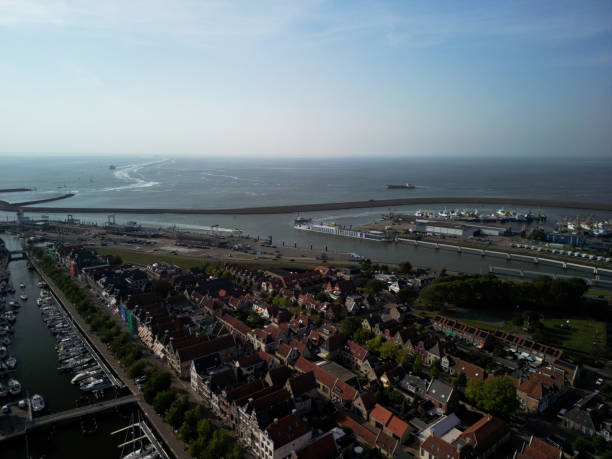 Harlingen, the Netherlands - September 14, 2023. Boats in a water canal in the city center at sunset.