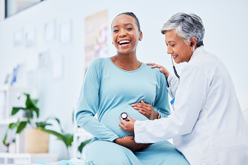 Doctor, woman portrait and heart rate pregnancy in a hospital with mama and baby care. Wellness, abdomen and pregnant healthcare with nurse and medical chart of a clinic check for health of a mother