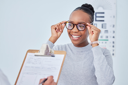 Black woman, glasses and vision, clipboard and paperwork with health insurance, prescription lens and frame. People at clinic, optometry and writing, checklist and info with eye care and documents