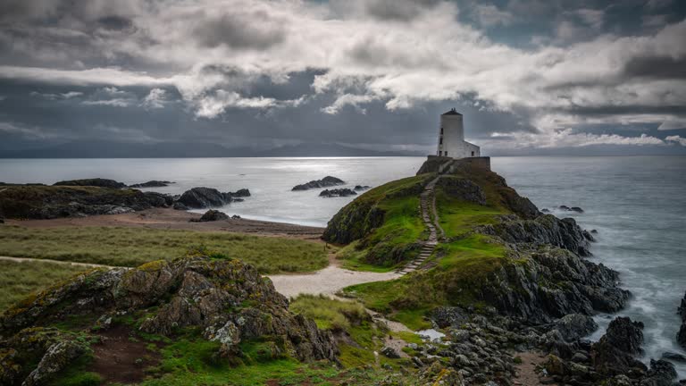 Coastline of Wales with Llanddwyn (Tŵr Mawr) lighthouse, Anglesey - UK