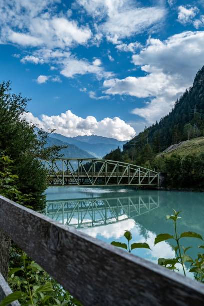 istock Vertical of a bridge on a river in green mountains 1682092863