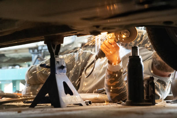 istock The mechanic uses the grinder to remove rust on a car. 1682111064