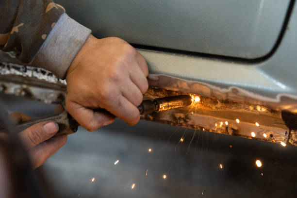 istock The mechanic uses a welding machine to repair a car threshold. 1682127342