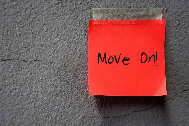 istock Red paper stick note on cracked old grey wall , with text written MOVE ON. time to leave for change or better life 1682149417