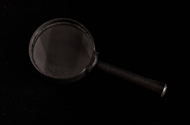 istock Vintage Magnify Glass Loupe on black, loupe background 1682163069