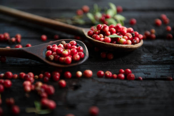 istock Fresh raw cranberry in wooden bowl on rustic table 1682173848