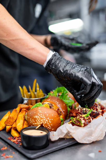 istock chef cooking fast food set on plate. burger, chicken wings on kitchen 1682176635