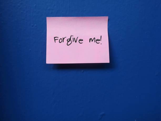 istock A pink note pad / post it stick on the grey painted cement wall, with a message FORGIVE ME, concept of making apology to someone 1682184912