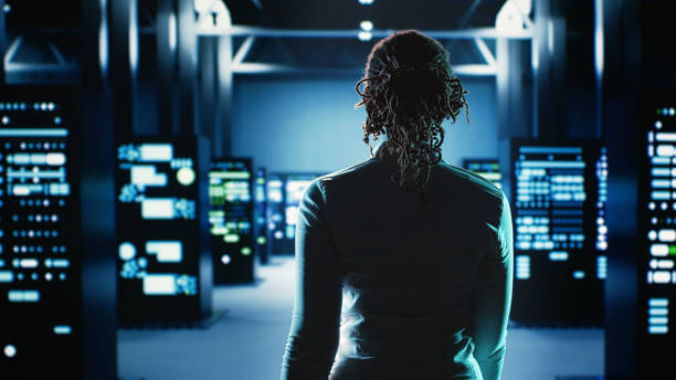 Engineer strolls through server rows Employee walking through data center infrastructure clusters providing processing resources for different workloads. Engineer inspecting server rigs tasked with solving complex operations supercomputer stock pictures, royalty-free photos & images