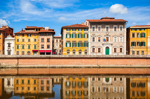 Colorful houses at the Arno river waterfront in the centre of Pisa city in Tuscany, Italy