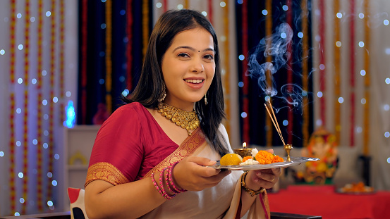 A young lady in a beautiful saree - house decoration, a Hindu festival, an auspicious occasion, an Indian festival of lights