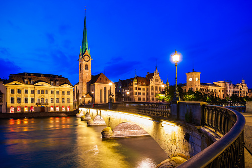 Fraumunster Church and Munsterbrucke bridge through Limmat river in the centre of Zurich city in Switzerland