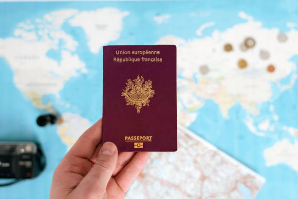 istock France Passport holding in hand with map 1682249303