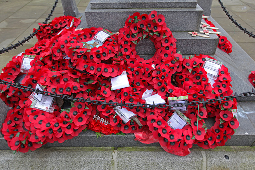 London, United Kingdom - January 25, 2013: Red Plastic Poppy Flowers Remembrance Wreaths at Monument in Capital City.