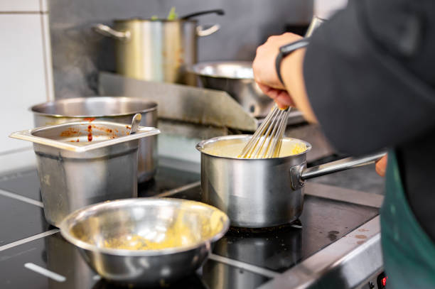 istock Chef hands cooking cheese sauce in the restaurant kitchen 1682262385