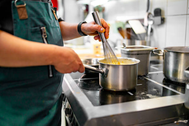 istock Chef hands cooking cheese sauce in the restaurant kitchen 1682262409
