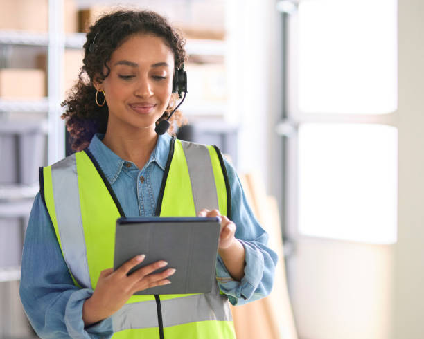 istock Woman Working In Warehouse Wearing Headset Using Digital Tablet 1682272265