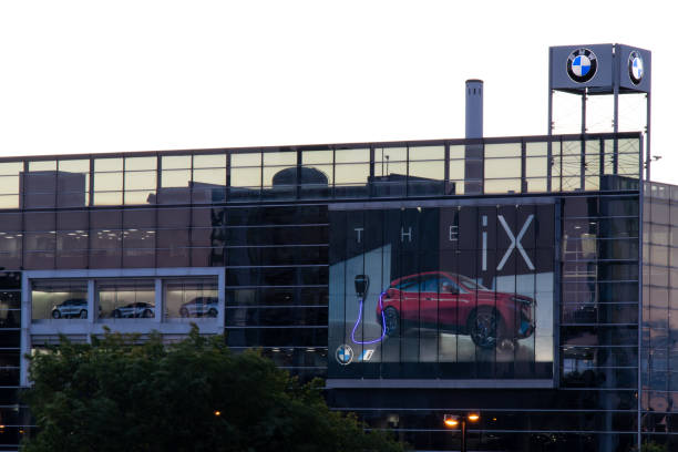 A BMW dealership at dawn in Toronto. A large BMW dealership, with a billboard for their new electric iX car, is seen illuminated at dawn in Toronto. bmw dealership stock pictures, royalty-free photos & images