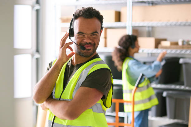istock Man With Down Syndrome Working In Warehouse Wearing Headset 1682273872
