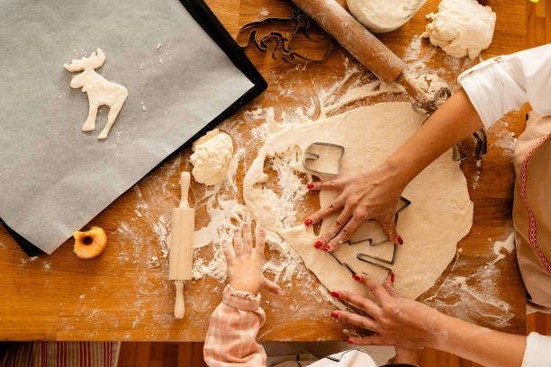 istock Mother and child making cookies together 1682276055