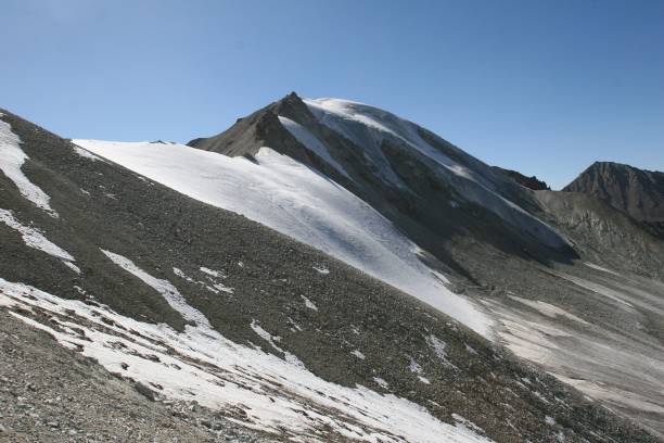 istock Snow-covered mountain, surrounded by rocks and gravel 1682277132