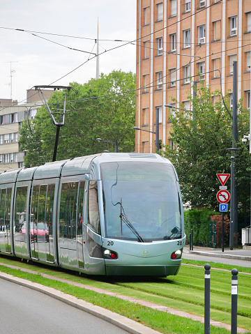 Tramway running in the city on grass-covered tracks, in Valenciennes