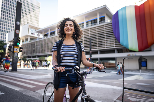 Portrait of a young woman tourist cycling in the city