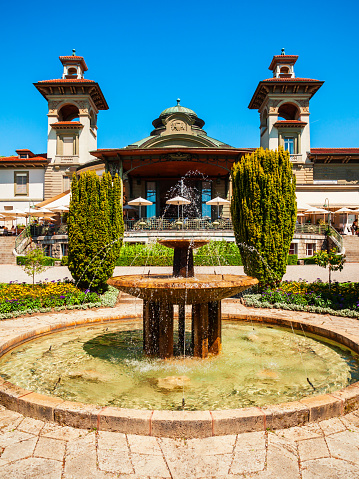 Fountain and historic building in the Esplanade of Montbenon park area of the city of Lausanne in Switzerland