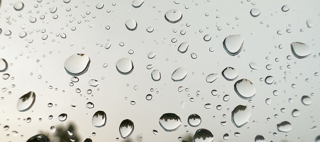 Rain drops on the window. Raining. Close up of the rain drops. Rainy.