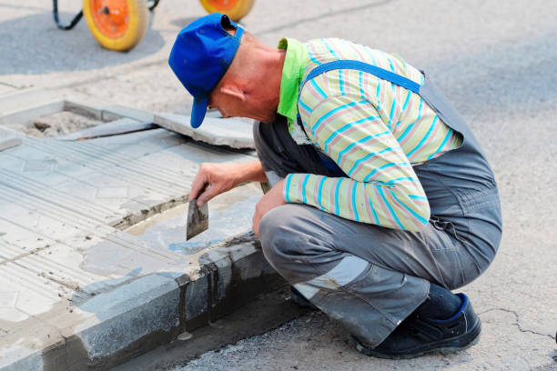 istock Bricklayer laying paving slabs on a summer day. Workflow view of caucasian builder 1682302665