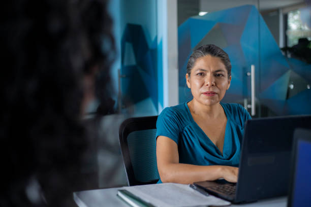 istock Non-binary and female Latinos working in the office 1682306588