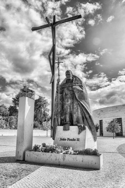 Sanctuary of Fatima holy Portugal Black and White Picture of the Statue of pope John Paul II and High Cross at Fatima, Portugal pope john paul ii stock pictures, royalty-free photos & images