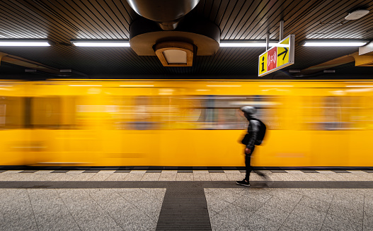 Germany, Berlin, September 08, 2023 - Blurred motion of person at subway station against leaving train Berlin Charlottenburg