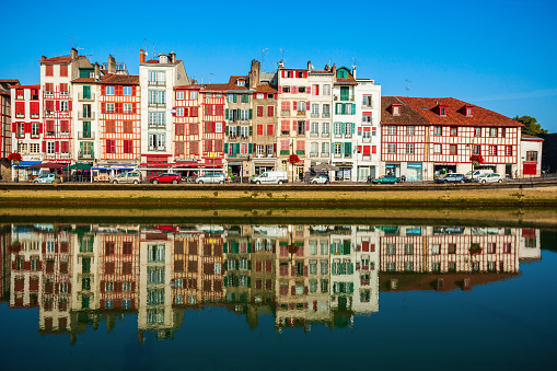 BAYONNE, FRANCE - SEPTEMBER 19, 2018: Colorful houses at the Nive river embankment in Bayonne town in France