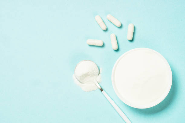 istock Collagen powder dietary supplement at blue. 1682330783