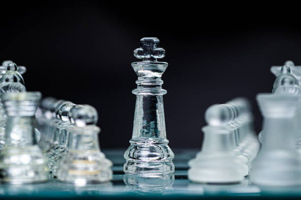 istock Transparent glass chess pieces on dark background. Leadership and  strategy concept, selective focus 1682349909