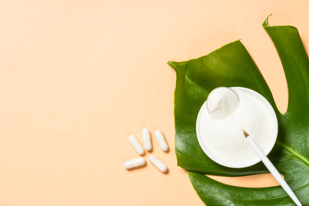 istock Collagen powder dietary supplement at blue. 1682350516