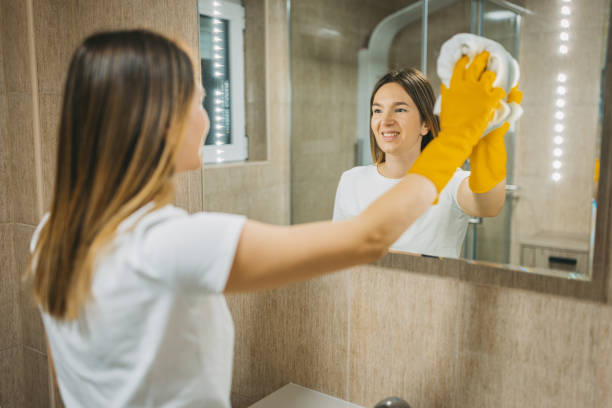 istock A mirror reflection of a woman cleaning bathroom 1682354895
