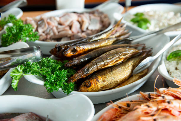 Delicious smoked Baltic herring on a plate. Seafood buffet lunch in a cafe in Finland