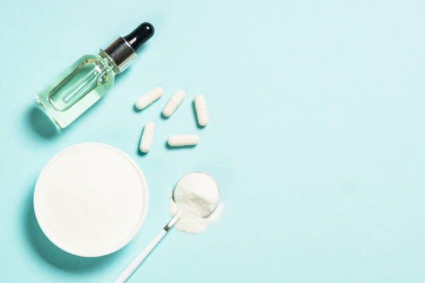 istock Collagen powder, capsules and serum at blue. 1682364255