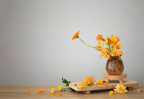 autumn bouquet on wooden shelf on background gray wall