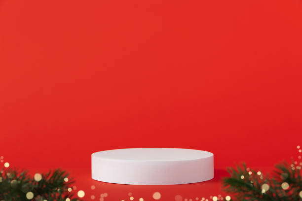 istock White podium and christmas decorations on red background. 1682420913