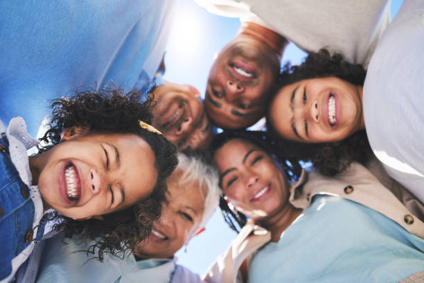 istock Happy family, face and smile in bonding, support or unity below together on weekend or summer vacation. Low angle of parents, grandparents and children huddle in happiness for fun holiday getaway 1682422545