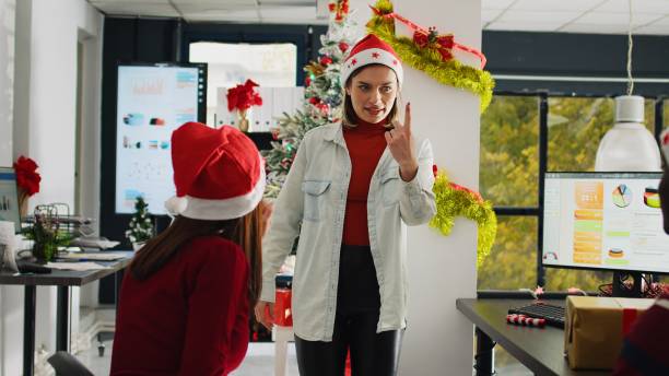 istock Employees play pantomime in xmas office 1682443448